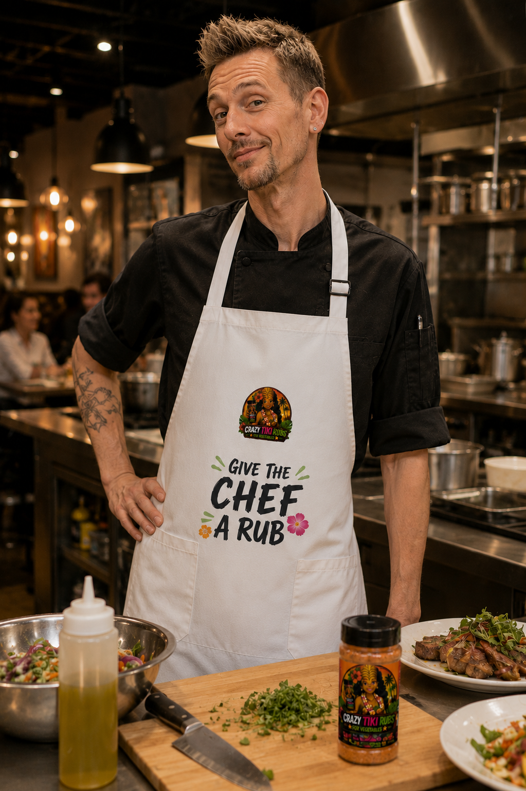 Chef wearing a white Crazy Tiki Rubs apron that reads Give the Chef a Rub, standing in a professional kitchen